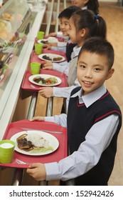 School Children Standing In Line In School Cafeteria