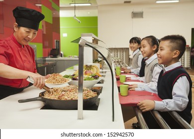 School Children Standing In Line In School Cafeteria