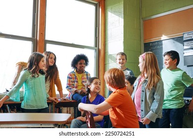 School, children and students talking in a classroom to learn, and study for knowledge and education. Diversity boy and girl group in class learning for future, development and growth at discussion - Powered by Shutterstock