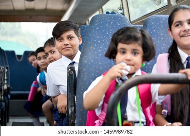 School Children Traveling In School Bus Looking At Camera