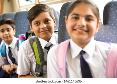 School Children Traveling In School Bus Looking At Camera