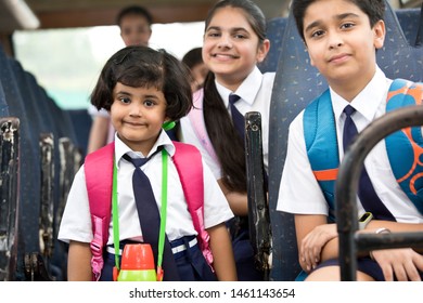 School Children Traveling In School Bus Looking At Camera