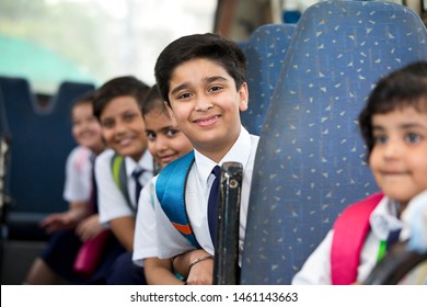 School Children Traveling In School Bus Looking At Camera