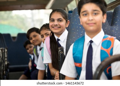 School Children Traveling In School Bus Looking At Camera