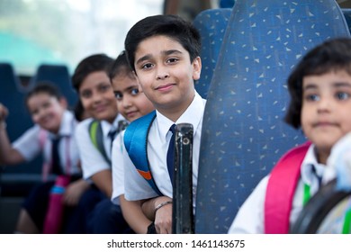 School Children Traveling In School Bus Looking At Camera