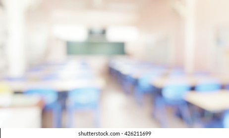 School classroom in blur background without young student; Blurry view of elementary class room no kid or teacher with chairs and tables in campus. - Shutterstock ID 426211699