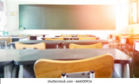 School classroom in blur background without young student; Blurry view of elementary class room no kid or teacher with chairs and tables in campus.
