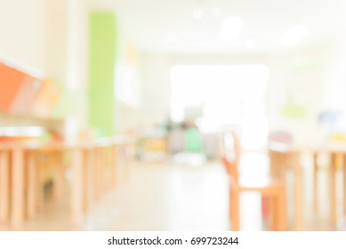 School Classroom In Blur Background Without Young Student; Blurry View Of Elementary Class Room No Kid Or Teacher With Chairs And Tables In Campus. Vintage Effect Style Pictures.