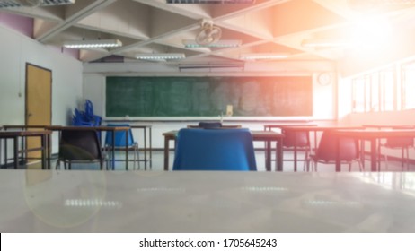 Schulzimmer geschlossen auf unscharfem Hintergrund ohne junge Studierende; Unscharfer Blick auf das leere Klassenzimmer ohne Kind oder Lehrer mit Stühlen und Tischen an der Universität.
