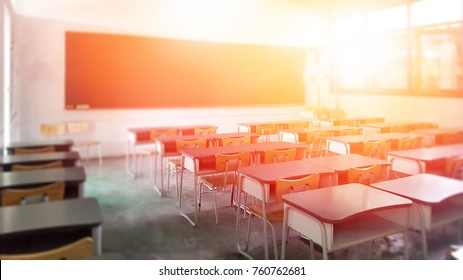 School classroom in selective focus background without young student; Blurry view of elementary class room no kid or teacher with chairs and tables in campus.