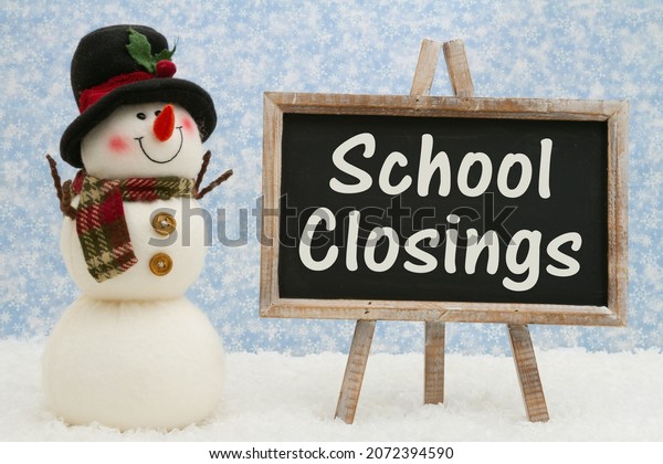 School Closings chalkboard sign\
with happy snowman with hat, ornaments, and snow with snowy sky\
