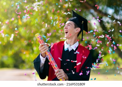 School Or College Graduation Ceremony. Young Man In Academic Regalia, Gown And Cap, Celebration Successful Diploma Certificate. High School Graduate In Robe, Stole And Mortar Board.