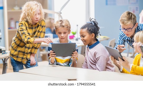 School Computer Science Class: Schoolchildren Use Digital Tablet Computers and Smartphones with Augmented Reality Software, They’re Excited, Full of Wonder. Children in STEM, Playing and Learning - Powered by Shutterstock