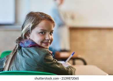 School Is Cool And She Loves It. Cropped Shot Of An Elementary School Girl In The Classroom.