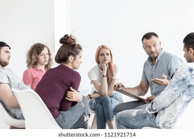 School counselor explaining anger management techniques to a group of teenagers