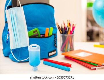 School COVID 19 Days. Coronavirus Protective Measures, Hand Sanitizer Gel And Medical Protective Masks. School Backpack And Supplies On Student Desk,