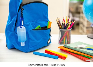 School COVID 19 Days. Coronavirus Protective Measure, Hand Sanitizer Gel And School Bag Backpack On Student Desk, Close Up View,