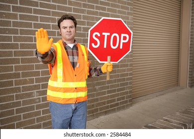 A School Crossing Guard Holding A Stop Sign.  Room For Text.