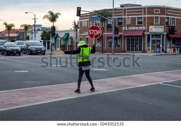 School\
crossing guard, Lomita, California March 7,\
2018