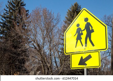 School Crossing Sign Against Trees 