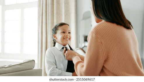 School, dressing and mom with girl in home getting ready for education, learning and classes. Family, morning routine and happy mother with child prepare with tie, uniform and clothes for academy - Powered by Shutterstock