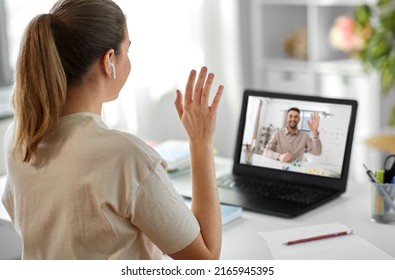 School, Education And Distance Learning Concept - Happy Smiling Female Student With Teacher On Laptop Computer Screen Having Video Call Or Online Class At Home