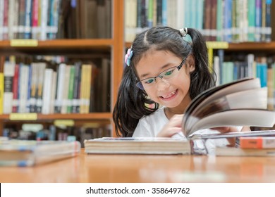 School education and literacy concept with Asian girl kid student learning or reading children's picture book in library or classroom - Powered by Shutterstock