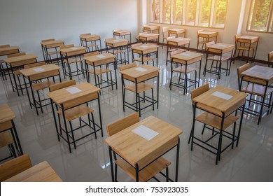 School empty classroom with test sheet or exams paper on desks chair wood and greenboard at high school thailand, education test concept