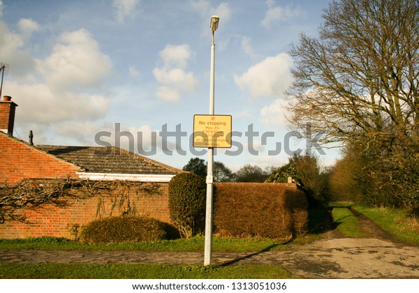 school\
entrance uk parking sign outside yellow cars\
rules