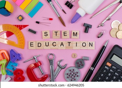 School Equipment With Word STEM Education Over Pink Background In Education STEM Concept. School Desk With Stationery Tools For STEM Learning.