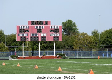 School Football Field With Scoreboard In Daytime.