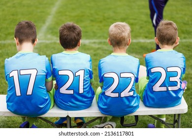 School Football Team. Soccer Players Sitting On Sideline Bench. Youth Soccer Players Sitting Together On Substitute Bench And Watching Match