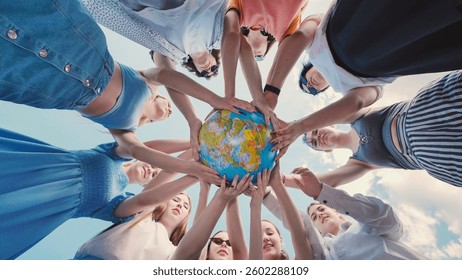 School friends demonstrate their commitment to environmental protection and global citizenship by holding a globe