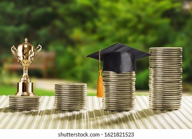 School Funding, Family Saving For Higher Education Concept : Black Graduation Cap, Campus Diploma, Money Jar, Trophy Cup Of Success Or Winner Reward, Clock On Rising Coins, Depicts Passage Of Success