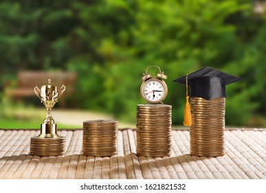 School Funding, Family Saving For Higher Education Concept : Black Graduation Cap, Campus Diploma, Money Jar, Trophy Cup Of Success Or Winner Reward, Clock On Rising Coins, Depicts Passage Of Success