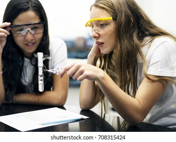 School girl friends learning science in the lab classroom - Powered by Shutterstock