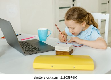School girl  has video call in remote classroom with teacher using laptop, happy little kid greeting with tutor, learning online on computer, home learning concept - Shutterstock ID 2190597807