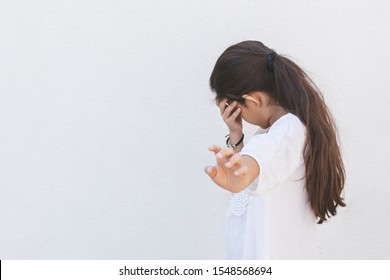 School Girl Hiding Face. A Girl Covering Face From View. Private Life And Paparazzi Concept. No Picture, No Photos, No Videos, Please. Home Violence. Fearful Child. Human Rights. Copy Space