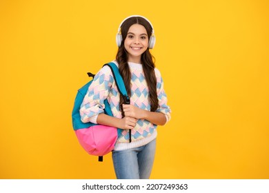 School Girl, Teenager Student In Headphones On Yellow Isolated Studio Background. School And Music Education Concept. Back To School.