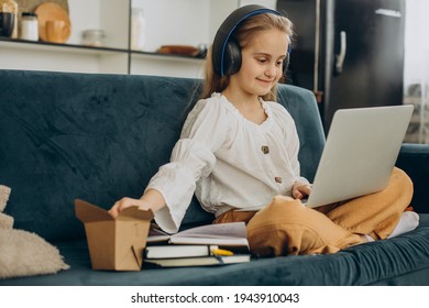 School Girl Watching Movie On Computer And Eating Popcorn