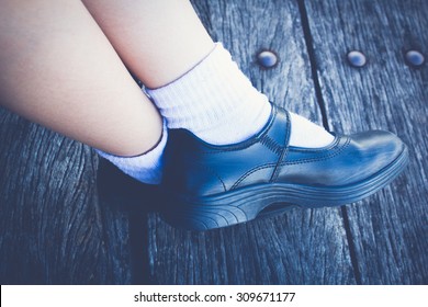 School Girl Wear A Black Leather Shoes As A School Uniform.