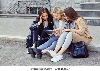 school girls using tablet computer. Students near university