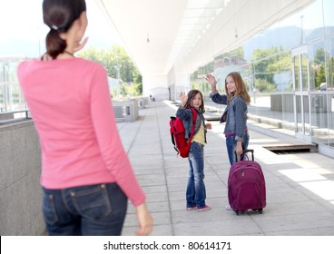 School Girls Waving Goodbye At Their Mother