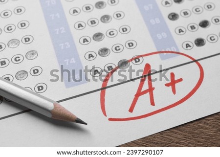 School grade. Answer sheet with red letter A, plus symbol and pencil on wooden table, closeup