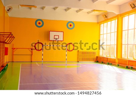 School gym with basketball and general gymnastics. Sunny day behind the window.