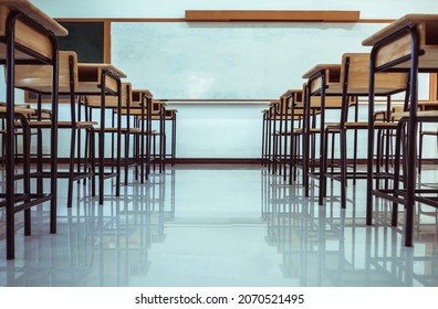 School interior of empty class room with board and seat when nobody or no student in classroom situation of Covid-19 disease outbreak and have to learning of distance teaching during COVID-19 - Shutterstock ID 2070521495