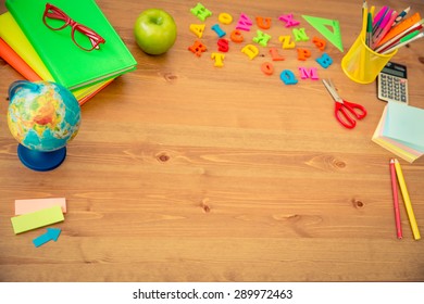 School Items On Wooden Desk In Class. Education Concept. Top View