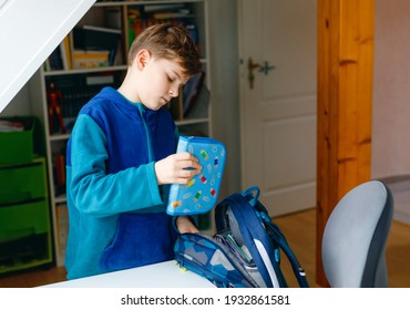 School Kid Boy Getting Ready In The Morning For School. Healthy Child Filling Satchel With Books, Pens, Folders And School Stuff. Preaparation, Routine Concept.