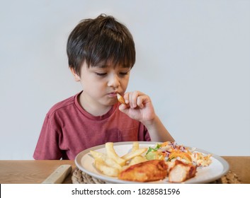 School Kid Eating Salmon Steak And Mixed Vegetables Salad For His Meal, Happy Child Having Healthy Lunch Or Dinnerat Home, Cute Boy Eating Mixed Organic Carrot And Chinese Cabbage