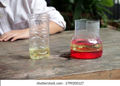 School Kid Making Oil And Water Separator Experiment At Home.Easy D.I.Y. Science Experiment.Experimenting With Oil,water And Dishwashing Detergent Is A Fun Way To Explore Basic Chemistry With Kids.